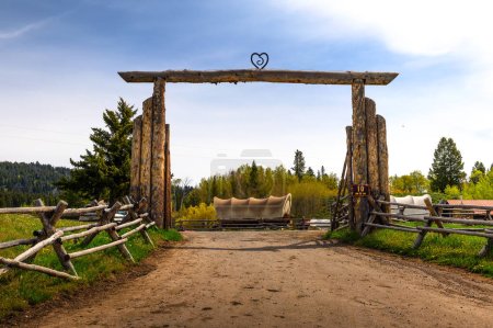 Photo for Moran, Wyoming, USA - June 8, 2022 : Entrance to Buffalo Valley Ranch located at the Snake River with historic carriages in the background. This ranch is located in Grand Teton National Park. - Royalty Free Image