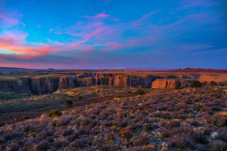 Photo for Sunset over Dead Indian Canyon in Arizona with vibrant sky and rugged cliffs. It is situated in the Paria Canyon-Vermilion Cliffs Wilderness and is known for its unique geological formations. - Royalty Free Image