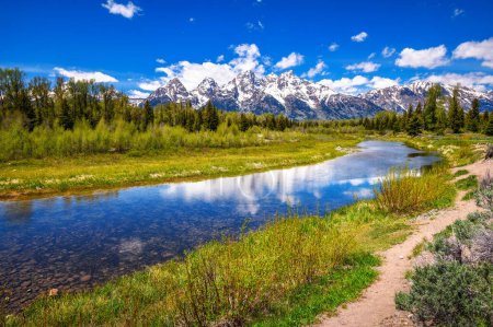Snake river with a clear view of the Grand Tetons, alongside a walking trail in Schwabacher Landing, Grand Teton National Park, Wyoming, USA.