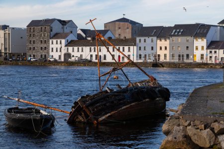 Part of the Galway waterfront, showing some old boats and buildings