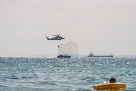 Photo for Helsingborg, Sweden - July 17 2021: Search and rescue helicopter AgustaWestland AW139 SE-JRL performing evacuation training at sea. - Royalty Free Image