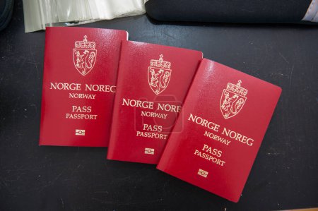 Photo for Oslo, Norway - july 18 2016: Tree norwegian passports on a black table. - Royalty Free Image