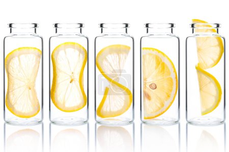 Photo for Homemade skin care lemon slice and lemon twist in glass bottles isolated on white background. - Royalty Free Image