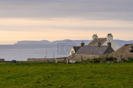Photo for Old houses in Thurso, Scotland, with a view on the Orkney Islands - Royalty Free Image