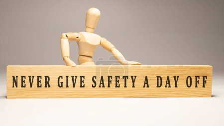 Photo for Never give safety a day off. Written on wooden surface - Royalty Free Image