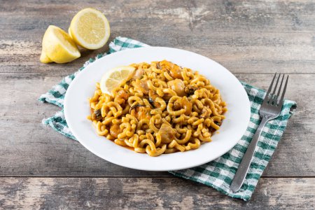 Photo for Traditional Spanish fideua. Noodle paella on wooden table - Royalty Free Image