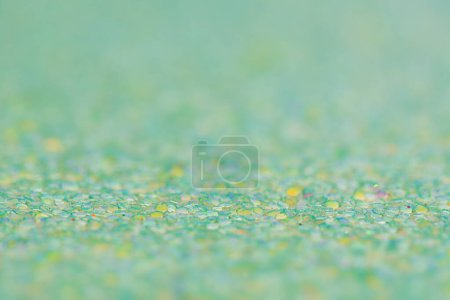 Photo for Macro photo of glitter paper. Green background with a thin focal part and a main part in defocus. - Royalty Free Image