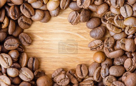 Photo for Roasted coffee beans on a wooden background. Coffee as background - Royalty Free Image