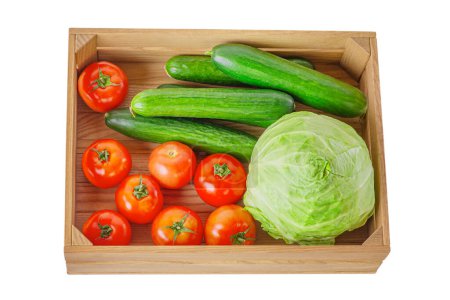 Photo for Cucumbers, tomatoes and cabbage in a wooden box isolate - Royalty Free Image