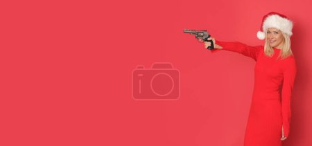 Photo for Christmas santa claus helper with pistol on red background. - Royalty Free Image