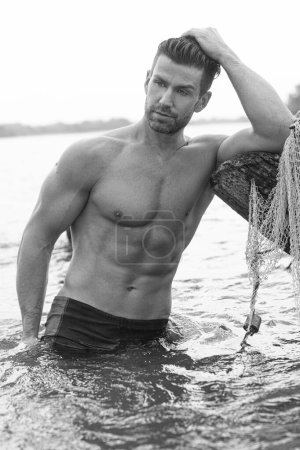 Foto de Handsome model with perfect body in sensual black and white photo shoot. - Imagen libre de derechos