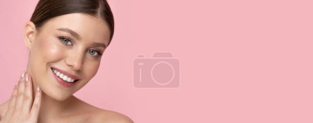 Téléchargez les photos : Young woman with clean skin and smile on isolated pastel pink background. - en image libre de droit