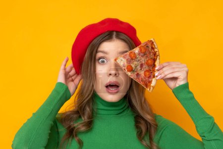 Foto de Pretty woman presents most delicious pizza on orange background. - Imagen libre de derechos