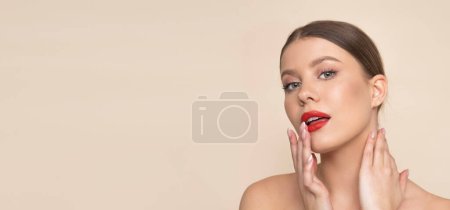 Téléchargez les photos : Beauty female with red lips on light brown background. - en image libre de droit