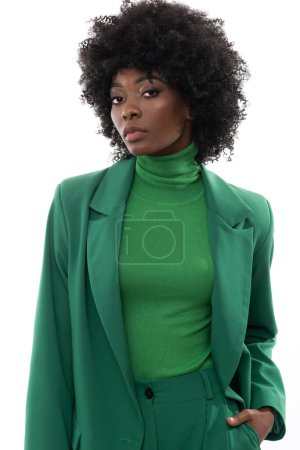 Foto de Fashionable brunette with green suit and handbag on isolated white background. - Imagen libre de derechos