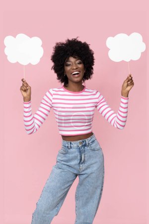 Foto de Happy African female model with white banners on pink background. - Imagen libre de derechos
