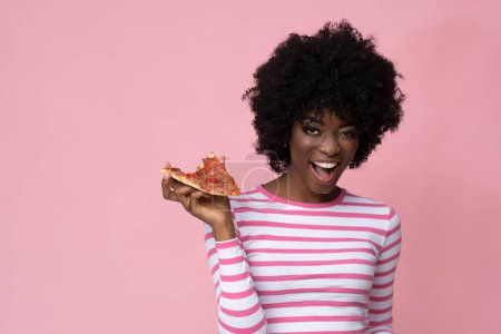 Photo for Positive woman with slice of pizza on pink background. - Royalty Free Image