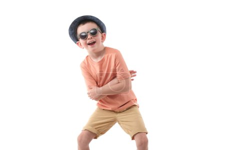 Photo for Little boy in fashionable clothes have a fun in photo studio. - Royalty Free Image