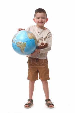 Photo for The young traveler is with the globe shows how important climate protection is. - Royalty Free Image