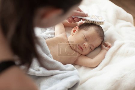 Photo for Cute newborn baby during care procedures. - Royalty Free Image