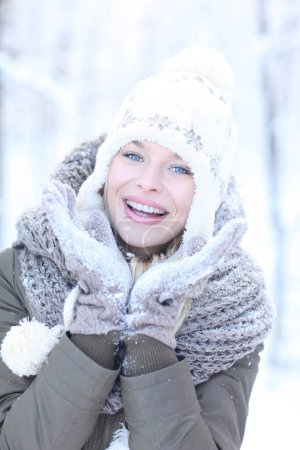 Photo for Happy blonde girl in a winter scenery with a hat and gloves. - Royalty Free Image