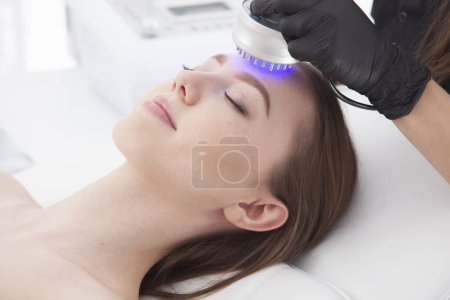 Photo for Patient of a beauty salon during facial treatments. - Royalty Free Image