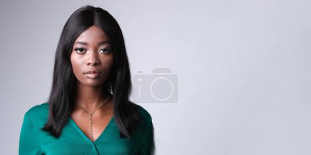 Photo for Woman with a serious face on a gray background. - Royalty Free Image