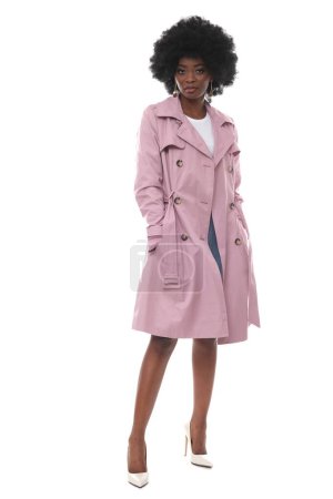 Photo for Beautiful young woman in a pink coat on a white background. - Royalty Free Image