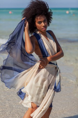 Photo for A beautiful black woman in a flowing dress. - Royalty Free Image