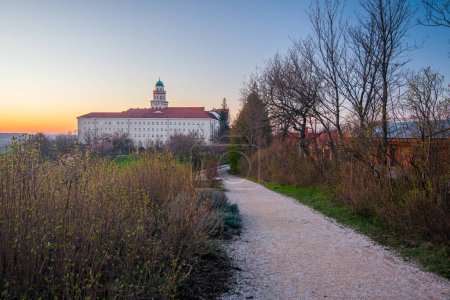 Pannonhalma Archabbey with the footpath at the sunset time in spring, Hungary