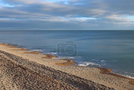 Foto de Las olas en el mar crean formas extrañas en la playa de guijarros en Seaton en Devon en la costa jurásica de la bahía de Lyme - Imagen libre de derechos