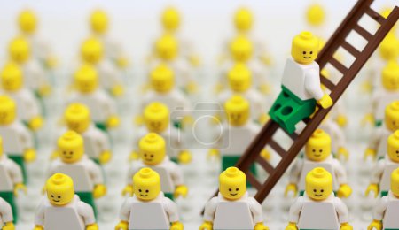 Photo for Hong Kong -April 23 2023: a man escape by the ladder, inside the crowd of bald people and become outstanding - Royalty Free Image