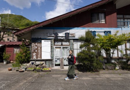 girl visit the the closed restaurant in the village of Kinugawa Onsen. 