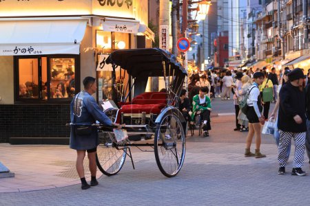 Photo for Tokyo -May 4 2023: unidentified man dress with edo style with rickshaw are waiting passenger. Uber Rickshaw is launched in Asakusa since 2023 - Royalty Free Image