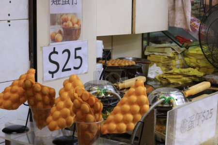 Photo for Egg waffle    is for sale in the street of Rua Do Cunha. Egg waffle is one of famous hong kong and macau street food - Royalty Free Image