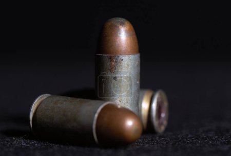 a close up of 11 mm. or .45 gun bullets , Full metal jacket ammunition