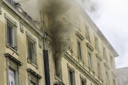 Photo for Naples, Italy - February 15th 2023 - Domestic apartment fire with smoke billowing from window. Garibaldi Square, Naples, Italy - Royalty Free Image