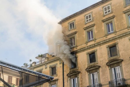 Photo for Naples, Italy - February 15th 2023 - Domestic apartment fire with smoke billowing from window. Garibaldi Square, Naples, Italy, landscape - Royalty Free Image
