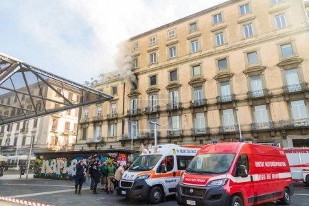 Photo for Naples, Italy - February 15th 2023 - Domestic apartment fire with smoke billowing from window. Garibaldi Square, Naples, Italy. Emergency vehicles attending, landscape. - Royalty Free Image