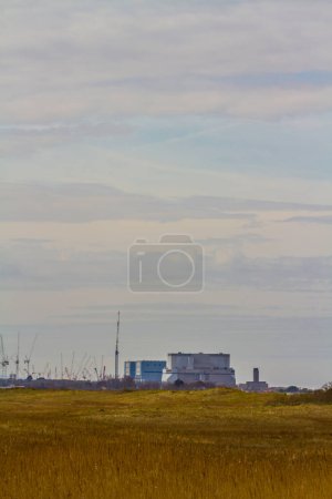 Photo for Hinkley Point Nuclear Power Station in distance, portrait, copyspace on top - Royalty Free Image