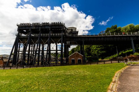 Photo for ANDERTON, ENGLAND  JUN 11  2022 View of the Anderton Boat Lift, vertically linking the River Weaver and the Trent and Mersey Canal, wide angle, landscape, side view showing whole structure - Royalty Free Image