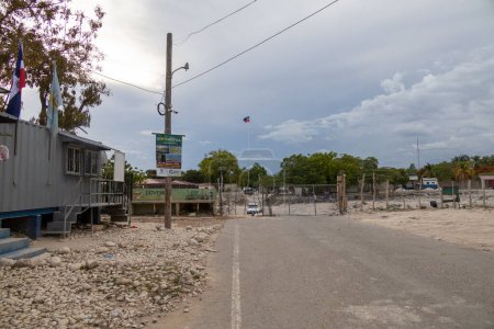 Photo for Pedernales, Dominican Republic 20 august, 2022. Wide angle view of the border with Haiti. Border closed with wire fence and gate, the town of Anse a Pitre on the other side. - Royalty Free Image