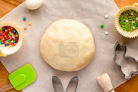 Photo for Dough for making Easter cookies, cookie cutters, sugar sprinkles. Festive Easter background for baking - Royalty Free Image