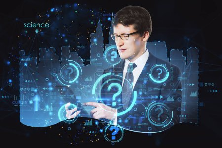 Attractive thoughtful young european businessman with tablet and abstract city hologram, question marks and business chart. Smart city and future concept. Double exposure