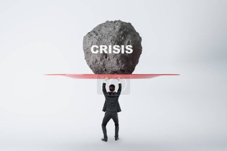 Photo for Anti-crisis management concept with businessman back view prevents huge stone from falling on his head with crisis sign on light background - Royalty Free Image