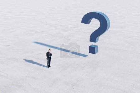 Photo for Answer concept with confused man in black suit and blue question mark on concrete surface - Royalty Free Image