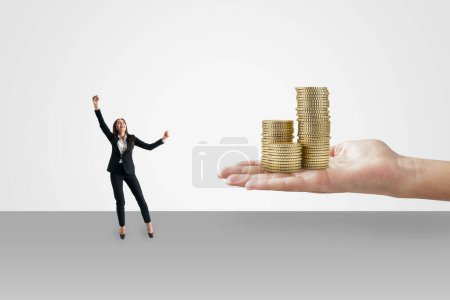 Winning the lottery concept with happy woman in black suit and human palm with golden coin stacks