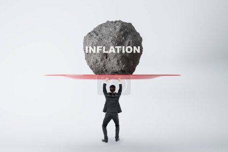 Photo for Crisis and anti-crisis management concept with businessman back view holding huge stone with inflation sign above his head, feeling tired on light background - Royalty Free Image