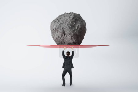 Photo for Success, power and strength concept with businessman back view holding huge stone above his head, feeling tired on light background - Royalty Free Image