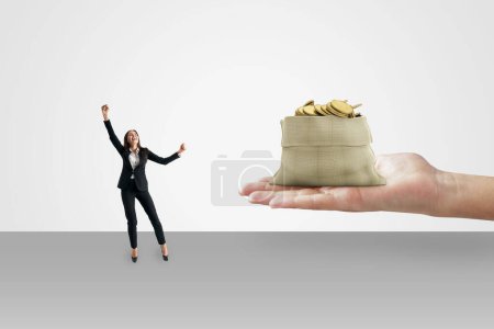 Investment in the future and business loan concept with happy businesswoman near human palm with bag with money